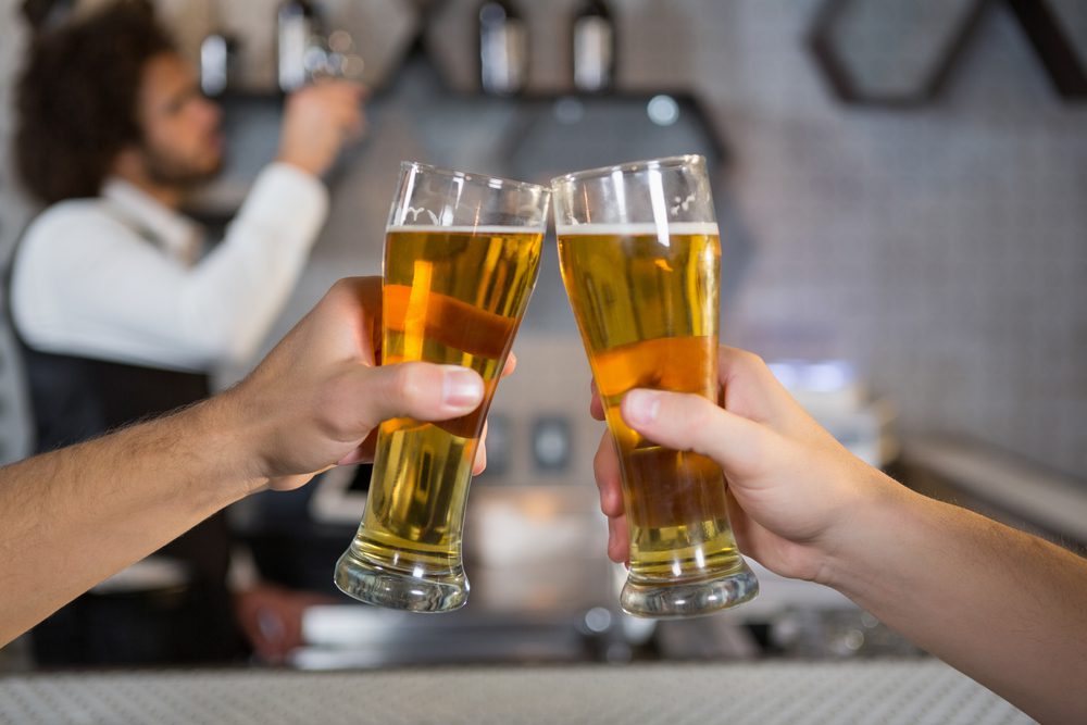 9 Things to do While in the Twin Cities 2 Two men toasting a glass of beer in bar